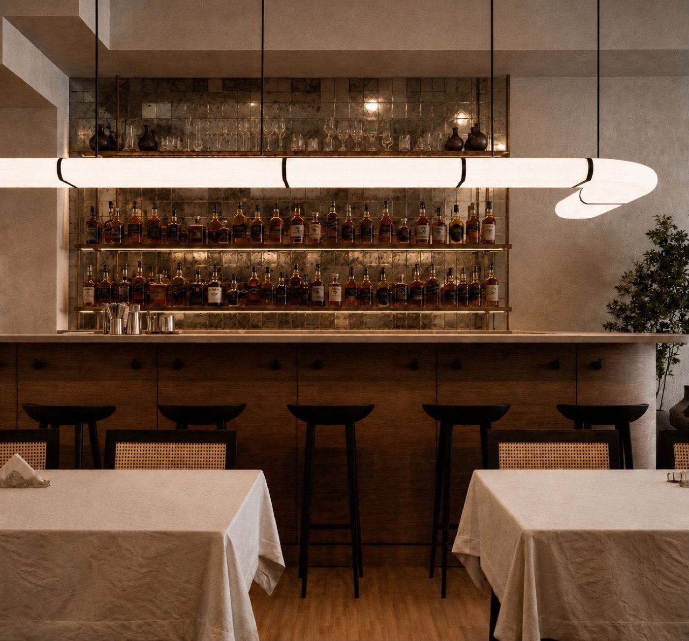 Bar counter with backlit bottle shelving and stools
